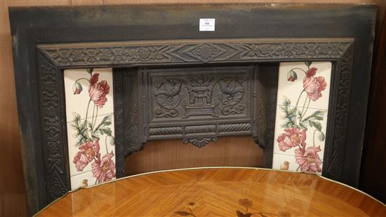 An Edwardian cast iron tiled fire insert W.97cm